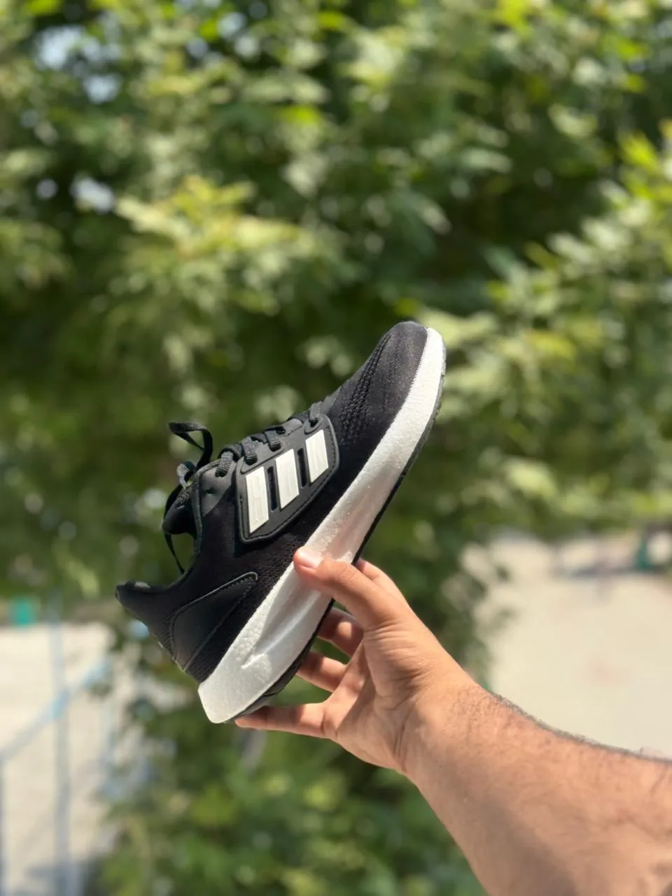 Side view of Adidas pureboost 22 Black & White