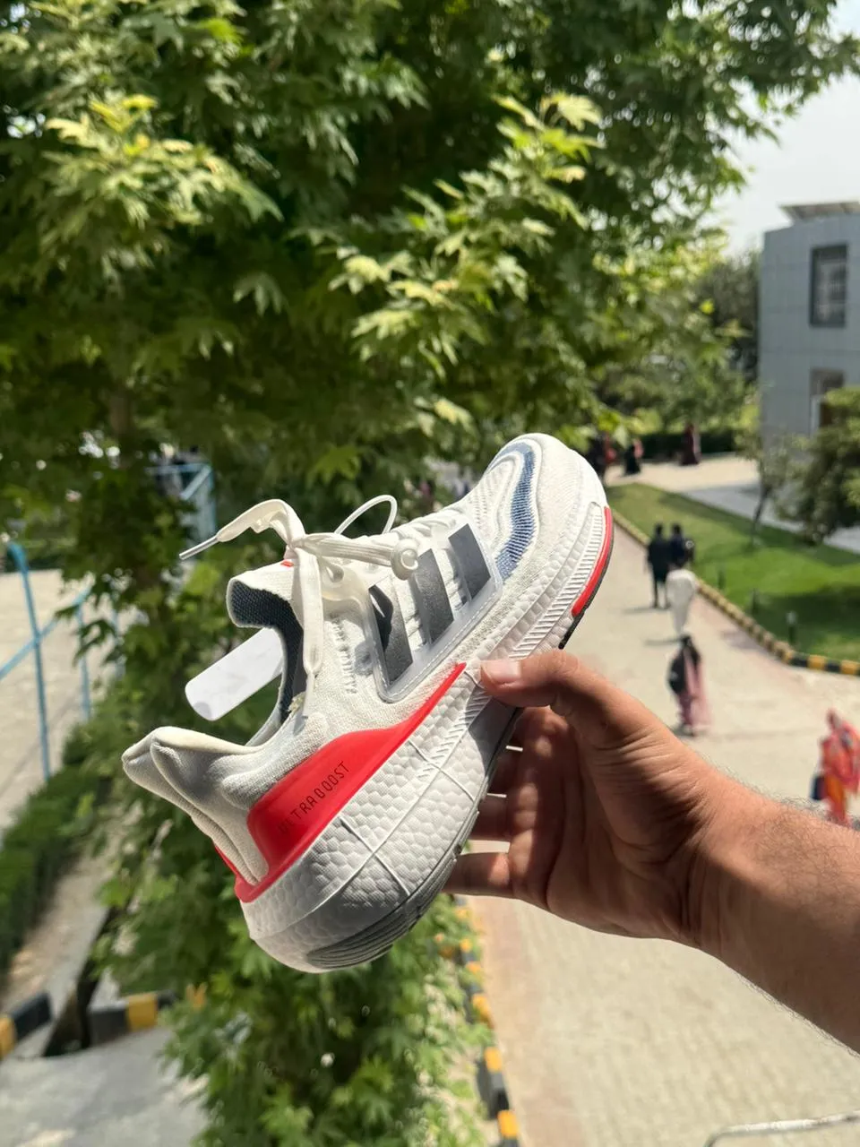 Side view of Adidas Ultraboost Light - Cloud White / Core Black / Solar Red